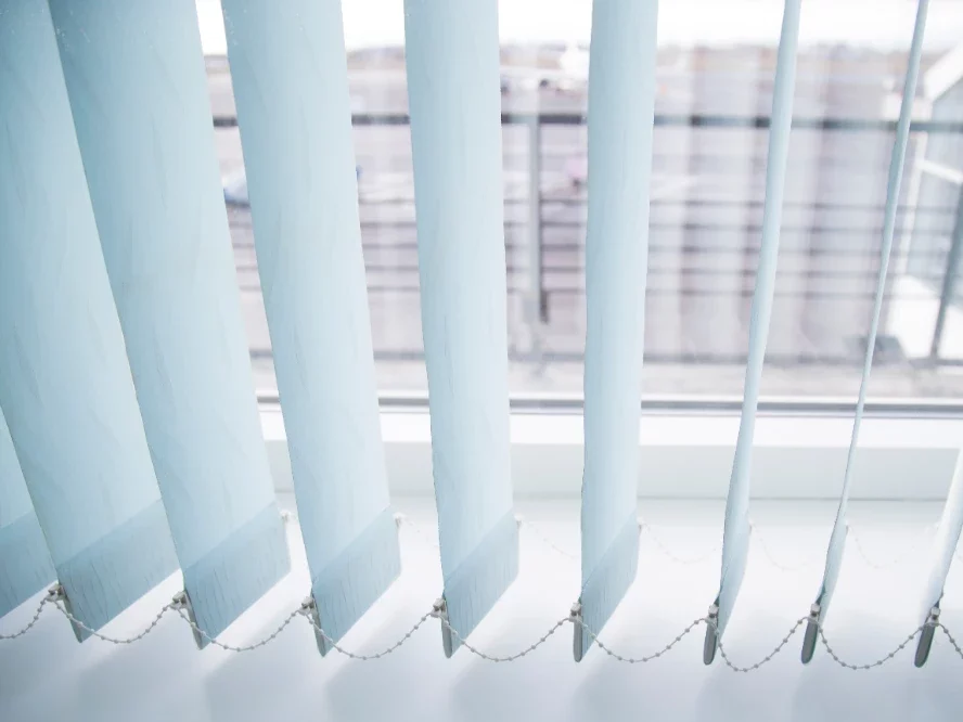 white vertical blinds just above the floor